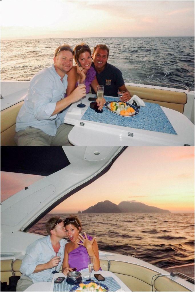 newly engaged couple drinking champagne on a boat