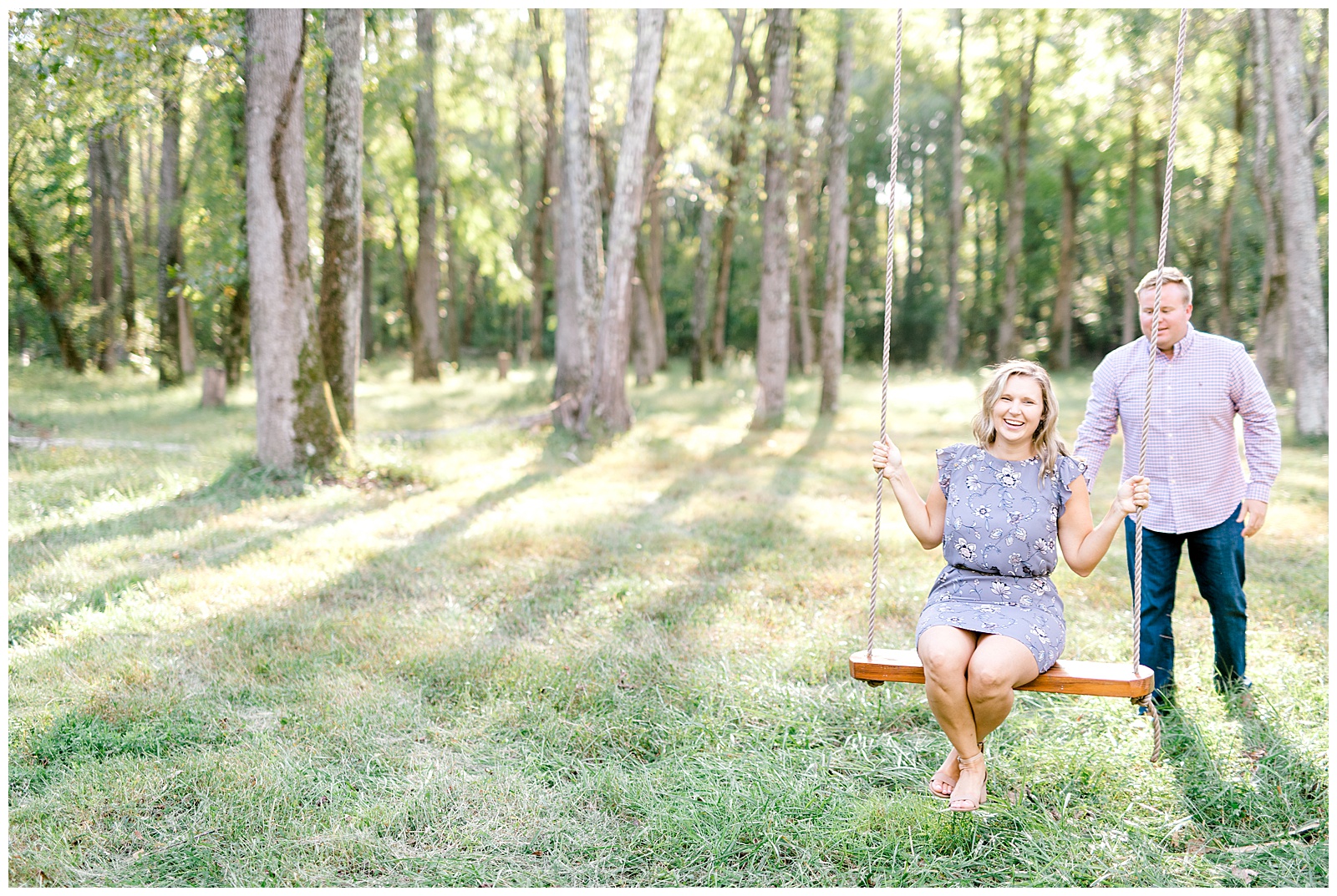 man pushing woman on swing during engagement session